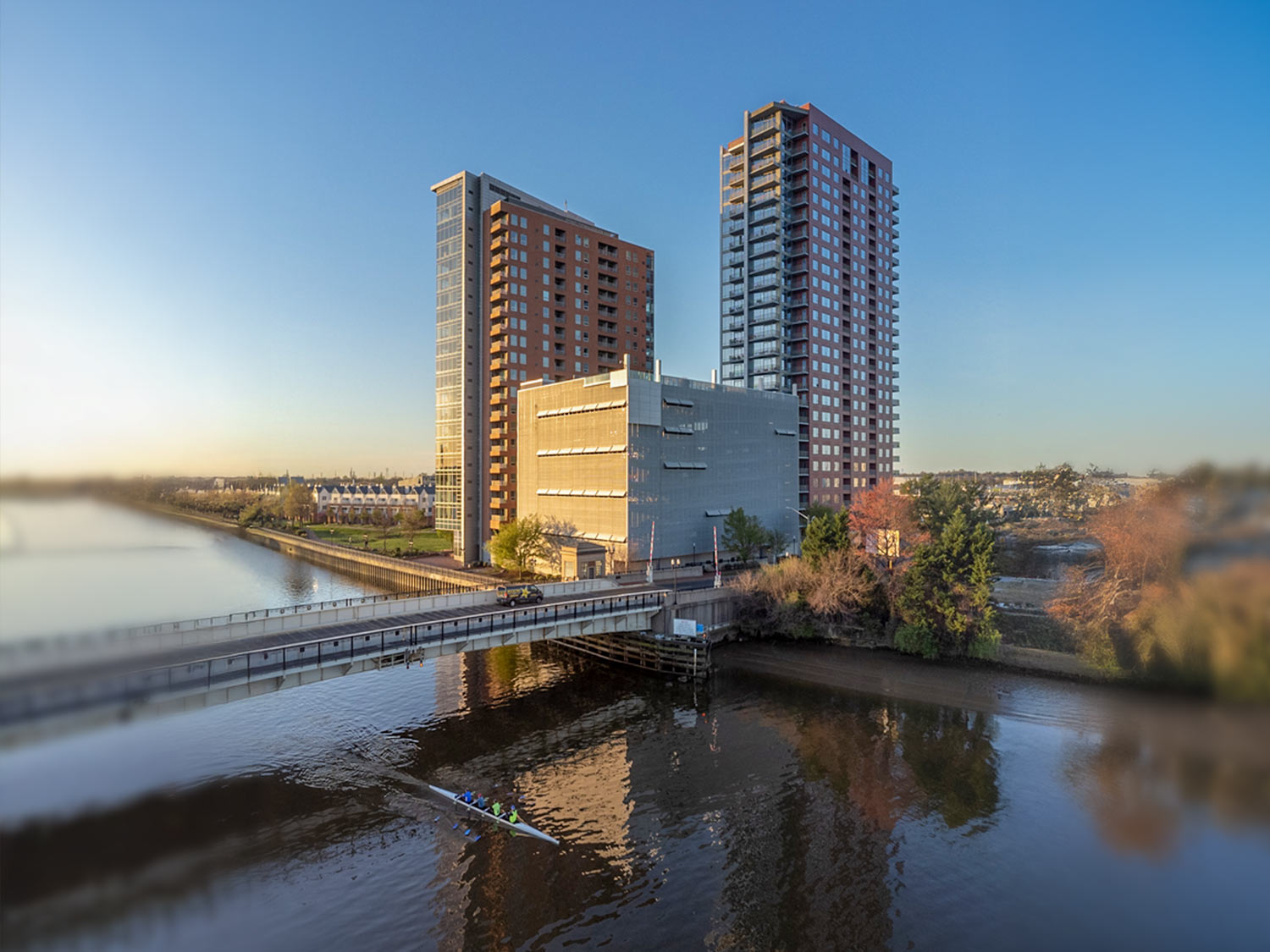Angled aerial photo showing buildings, river access, and surrounding urban area