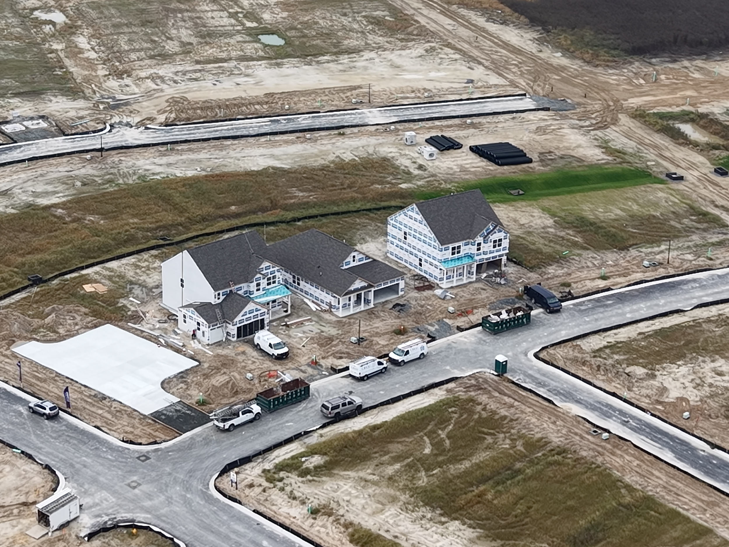 Angled drone photo showing active residential construction progress and work in place