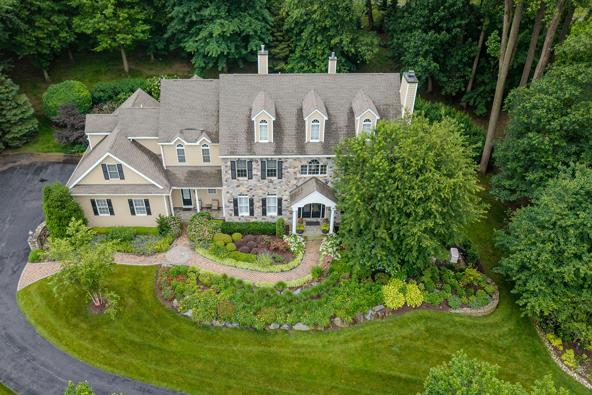 Aerial drone photo showing completed landscaping and grounds of a large estate property