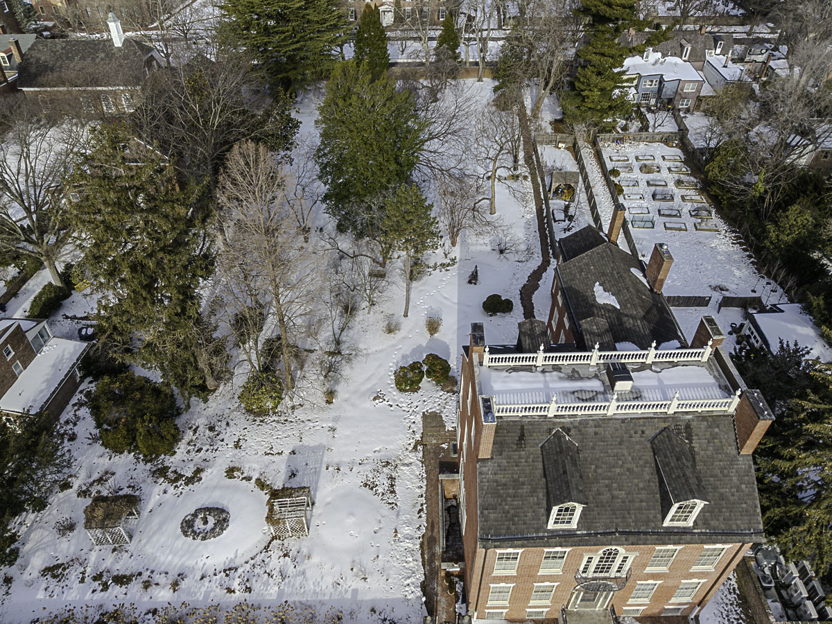 Oblique aerial view of Read House and Gardens in Old New Castle Delaware showing snow-covered grounds, historic mansion, and neighboring properties before restoration work began